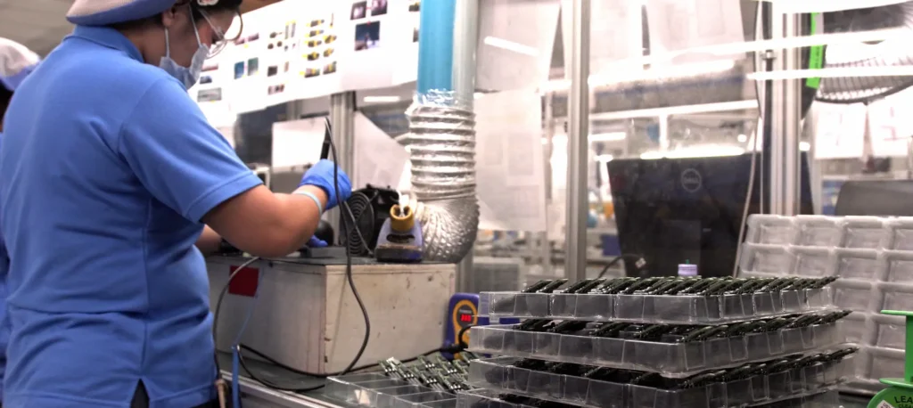 technician working on PCB assembly during a controlled manufacturing ramp-up. Reasons Manufacturing Ramp-Ups Fail